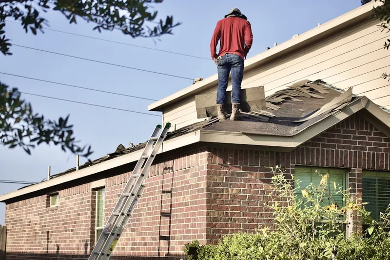 Professional roofer working on a residential roof in Harrisburg